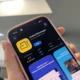 A close-up shot of an iPhone screen displaying the Arattai Messenger app page in the app store, which clearly shows the app's logo, a 4.7-star rating, and the text "CHART No.1 Social Networking."