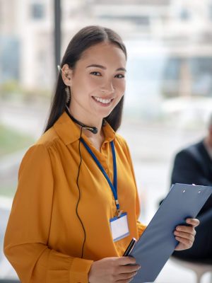 young-pretty-asian-woman-with-a-badge-smiling-nice-2024-10-11-17-53-32-utc-scaled.jpg